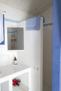 a white bathroom with a sink and a mirror at Le Clos De La Combe in Saint-Jean-dʼOrbetiers +30 photos