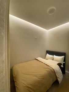 a bedroom with a bed in a white room at Modern and Cozy 3BR Staycation Home in Tarlac