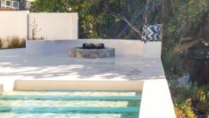 a fountain in the middle of a pool in a yard at Salt & Sand in Wilderness
