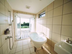 a bathroom with a sink and a toilet and a window at Suu -瀬戸内の小さな別邸 in Futami +34 photos
