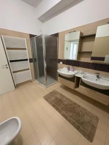 a bathroom with two sinks and a shower at I Rimarici in Pavia +39 photos