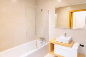 a bathroom with a sink and a shower at Ocean Green Retreat Lagos in Lagos