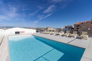 a swimming pool on the roof of a building at Ocean Green Retreat Lagos in Lagos