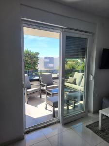 a sliding glass door with a view of a patio at Apartment Mare D with a pool new in Novalja