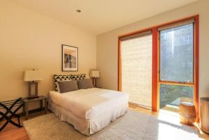 a bedroom with a bed and a large window at ALOFT Airy Design with River View in Hood River