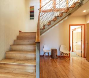 a staircase in a house with two chairs at ALOFT Airy Design with River View in Hood River