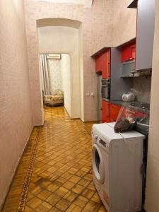 a kitchen with a washing machine in the middle of a room at Mehrz Globway services in Baku +2 photos