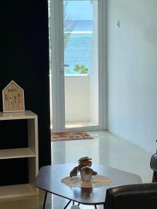 a teddy bear sitting on a table in a living room at Spacious 3 bed seaview apartment in Flic-en-Flac