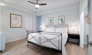 a bedroom with a bed and a ceiling fan at Sans Souci Unit 204 in Villa Sabine