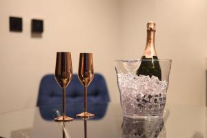 a bottle of champagne in a vase on a table at Luxury Flat,Sauna, Jacuzzi, Free Parking in Finchley