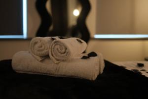 a pile of towels sitting on top of a bed at Luxury Flat,Sauna, Jacuzzi, Free Parking in Finchley