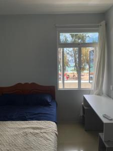 a bedroom with a bed and a window at Spacious 3 bed seaview apartment in Flic-en-Flac