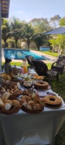 a table with a bunch of food on it at Chácara Vale do Sol in Valença