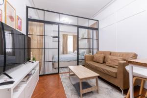 a living room with a couch and a table at 1BR Condo with Free Parking at SMDC Trees Residences, Fairview Quezon City in Manila