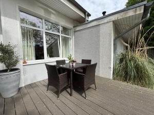 a patio with a table and chairs on a deck at Haus OstseeWelle - Wohnung 10 in Dahme