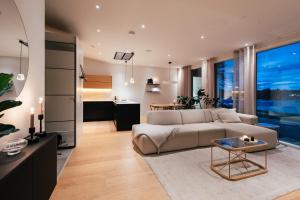 a living room with a couch and a table at Lapland Riverside Escape in Rovaniemi