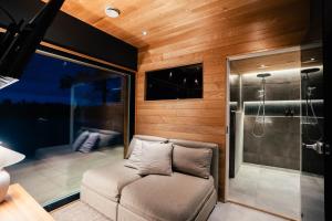 a small room with a couch and a shower at Lapland Riverside Escape in Rovaniemi +23 photos