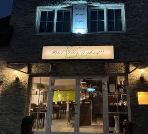 a restaurant with a sign on the side of a building at Boutique Hotel Villa Stockum in Düsseldorf