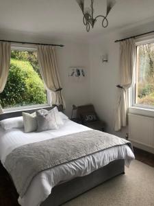 a bedroom with a bed and a large window at Snowdonia Mawddach escape in Dolgellau