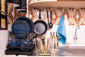 a kitchen counter with pots and pans and a sink at HeritageLuxuryHomes in Gitura