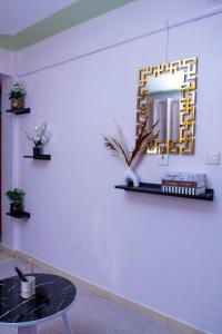 a room with a table and a mirror on the wall at HeritageLuxuryHomes in Gitura