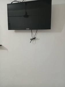 a flat screen tv sitting on top of a table at Hotel posada sol in Villa Carlos Paz