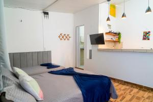 a bedroom with two beds and a flat screen tv at Vila Davi Jeri - Flats e Casa in Jericoacoara