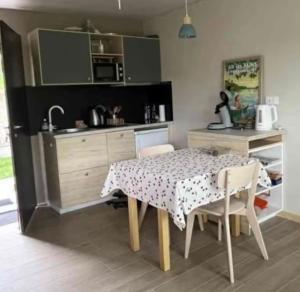 a kitchen with a table and chairs in a kitchen at Orevard coin de paradis in Aix-les-Bains