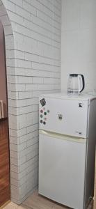 a white refrigerator with a blender on top of it at Апартаменты на Новых Домах in Kharkiv