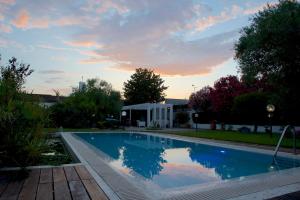 a swimming pool in a yard with a sunset at Casa Lupita - Private Family Villa with Pool & Garden in Terracina