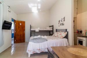 a small bedroom with a bed in a room at Vila Davi Jeri - Flats e Casa in Jericoacoara