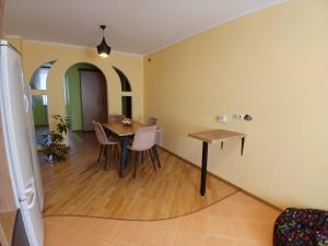 a kitchen and dining room with a table and chairs at Spacious apartment in the center of Vinnytsia in Vinnytsya +8 photos