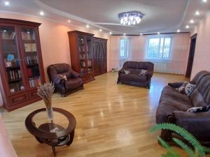 a living room with leather couches and a table at Spacious apartment in the center of Vinnytsia in Vinnytsya
