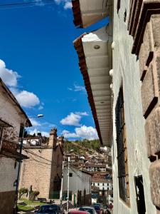 a view of a city from between two buildings at Ayni Boutique Hotel in Cusco