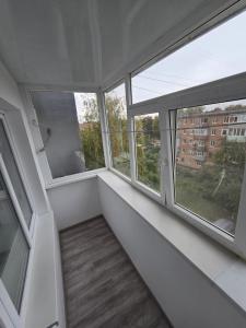 an empty room with three windows in a building at 1 кімнатна квартира в центрі міста in Sumy +4 photos