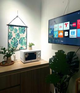 a microwave sitting on a counter with a tv at Aurora Homestay in Hanoi