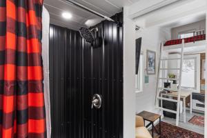 a room with a black and orange curtain at Maple Sugar Shack Tiny House with hot tub & river by Stowe in Johnson +47 photos