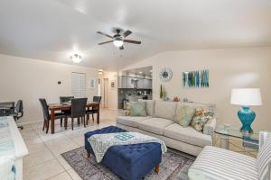 un soggiorno con un divano e un tavolo di Beachy Retreat - Atlas Duplex a Satellite Beach