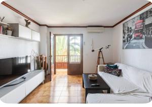 a living room with a couch and a table at La casita del puerto in Agaete