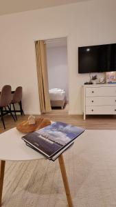 a living room with a table with a keyboard on it at Deichliebe 3 - gemütlich, zentral und modern- Inklusive privater Stellplatz im Parkhaus 2min zu Fuß entfernt in Bremerhaven