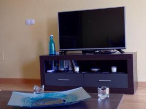 a flat screen tv sitting on top of a entertainment center at Turquesa Cotillo in Cotillo