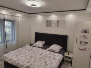 a bedroom with a bed with two pillows on it at Appartement meublé Rixheim Alsace in Rixheim