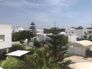 a view of a city with white buildings at Aux jardins de Hammamet in Hammamet