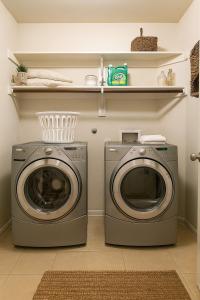 a laundry room with a washer and dryer at Spacious 3BR Home w Game Room, Gym & Study in McKinney