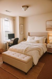a bedroom with a large bed and a desk at Spacious 3BR Home w Game Room, Gym & Study in McKinney