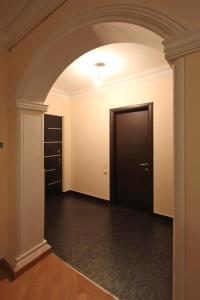 an empty room with a black door and a hallway at Caliseum Sayat-Nova 33 in Yerevan