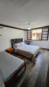 Postel nebo postele na pokoji v ubytování Surfside Boiçucanga
