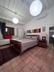 a large bedroom with a large bed in a room at La Rosa dei Monti Iblei in Ferla