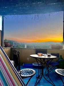 a table and chairs on a balcony with a view at La Rosa dei Monti Iblei in Ferla
