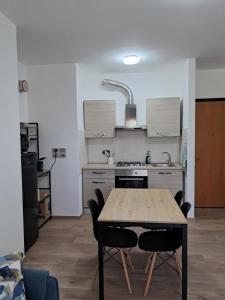 a kitchen with a table and chairs in a room at Interno 10 in Capolona